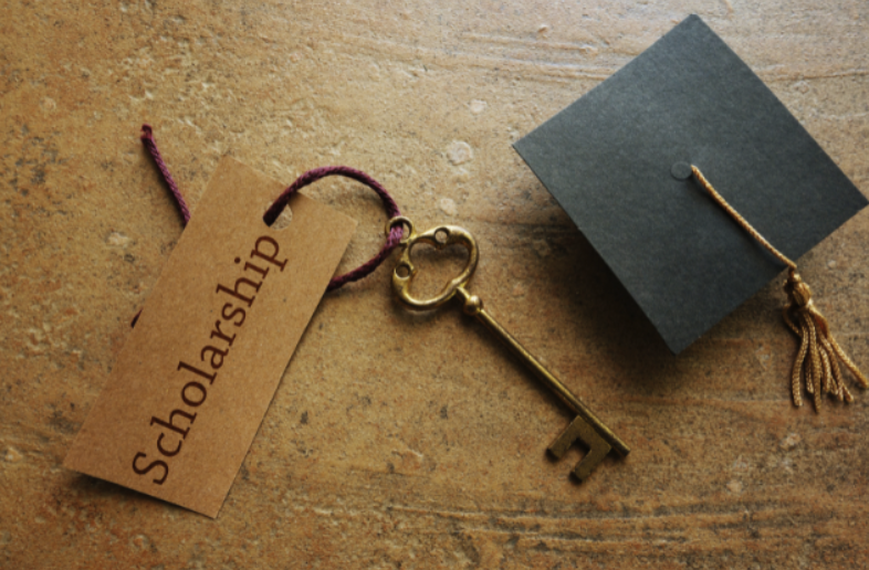 Scholarship key and graduation cap.